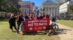 Demonstrators marched to the Hale-Boggs Federal Building under a banner saying "No to NATO" Demonstrators marched to the Hale-Boggs Federal Building under a banner saying "
