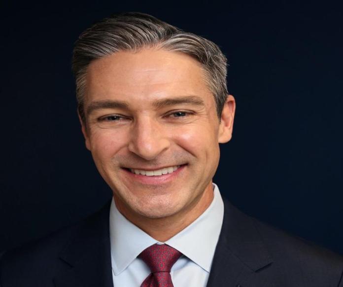 A person in a suit and tie Description automatically generated with medium confidence
