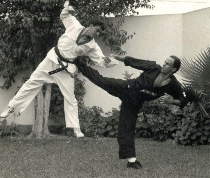 A person kicking another person in the face
Description automatically generated with medium confidence