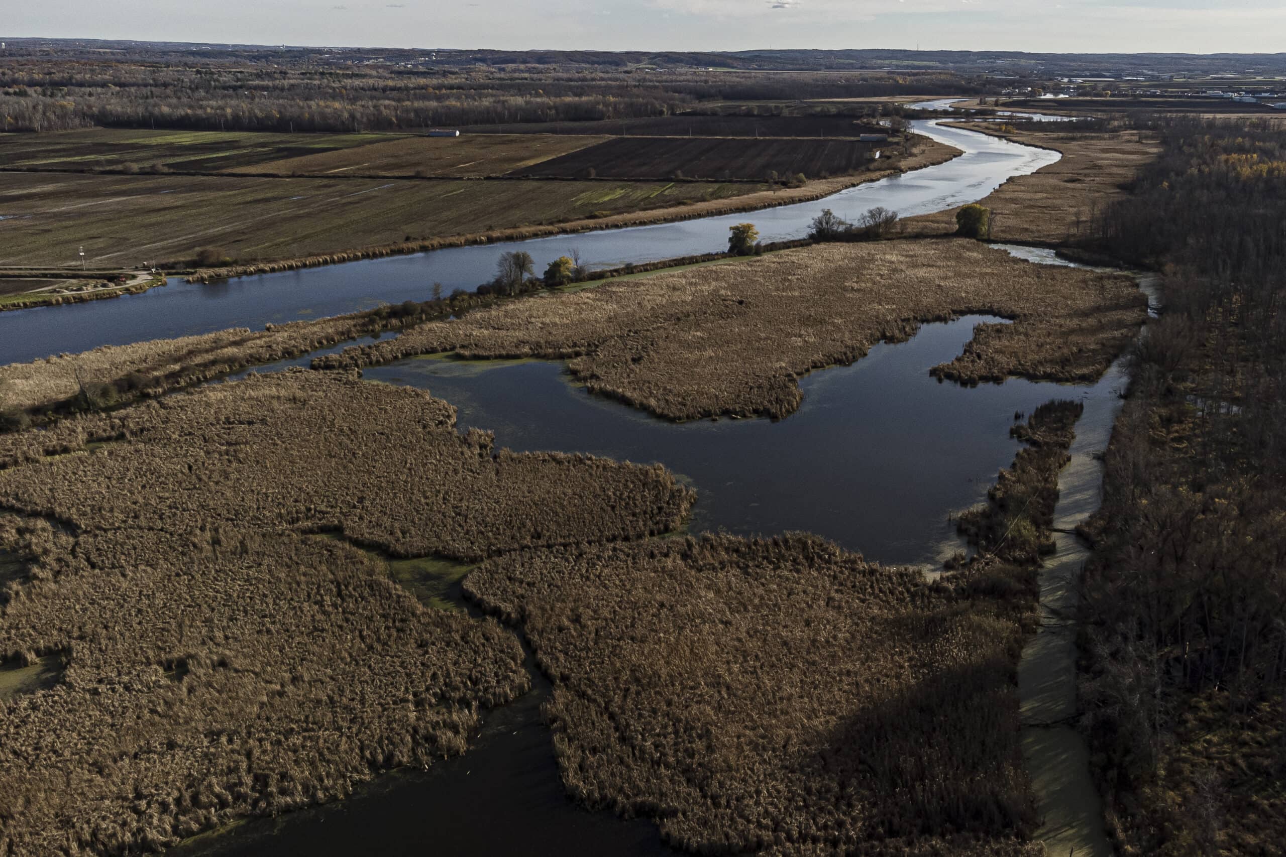 The Holland River in Ontario's Greenbelt winds past farm fields in late autumn.