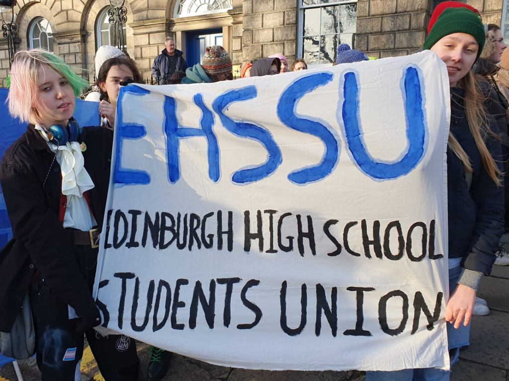 Students hold a banner saying 'EHSSU: Edinburgh High School Students Union', outside Bute House.